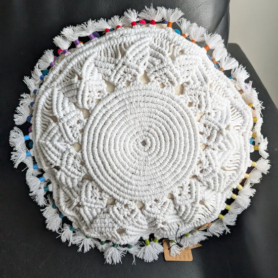 Round woven mat with colorful edges on a black chair