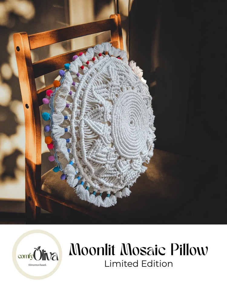 Decorative moonlit mosaic pillow with colorful accents on a wooden chair, featuring the brand 'Oliva'.