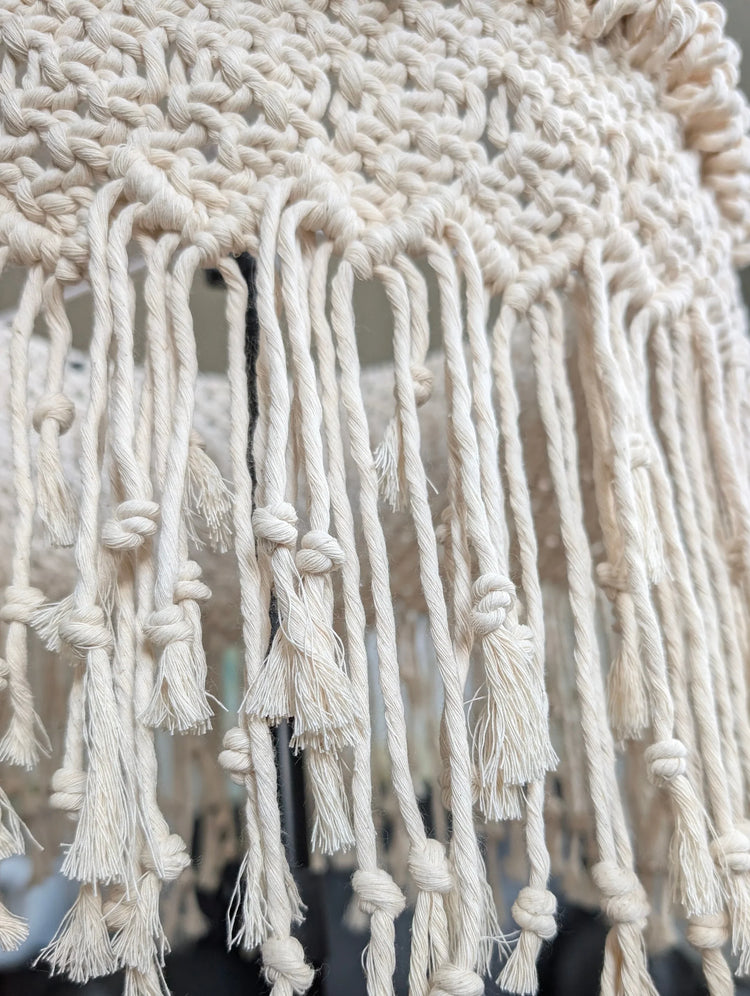 Close-up of a macrame lampshade with tassels